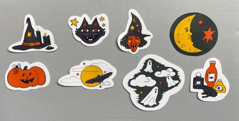 8 different stickers: a witch&#x27;s hat and 2 candles, a black cat and yellow stars, orange witch, a crescent moon with 2 orange stars, Jack O&#x27;Lantern, a bat around a full moon, 3 ghosts flying in the sky with 2 clouds, a frog w by 3 potions.