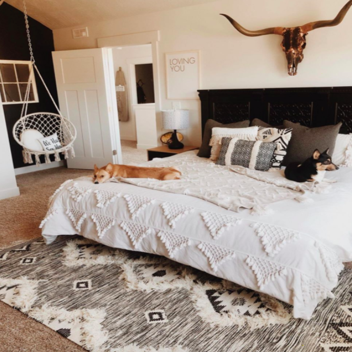 Gray and white diamond-print shaggy rug under a full-size bed