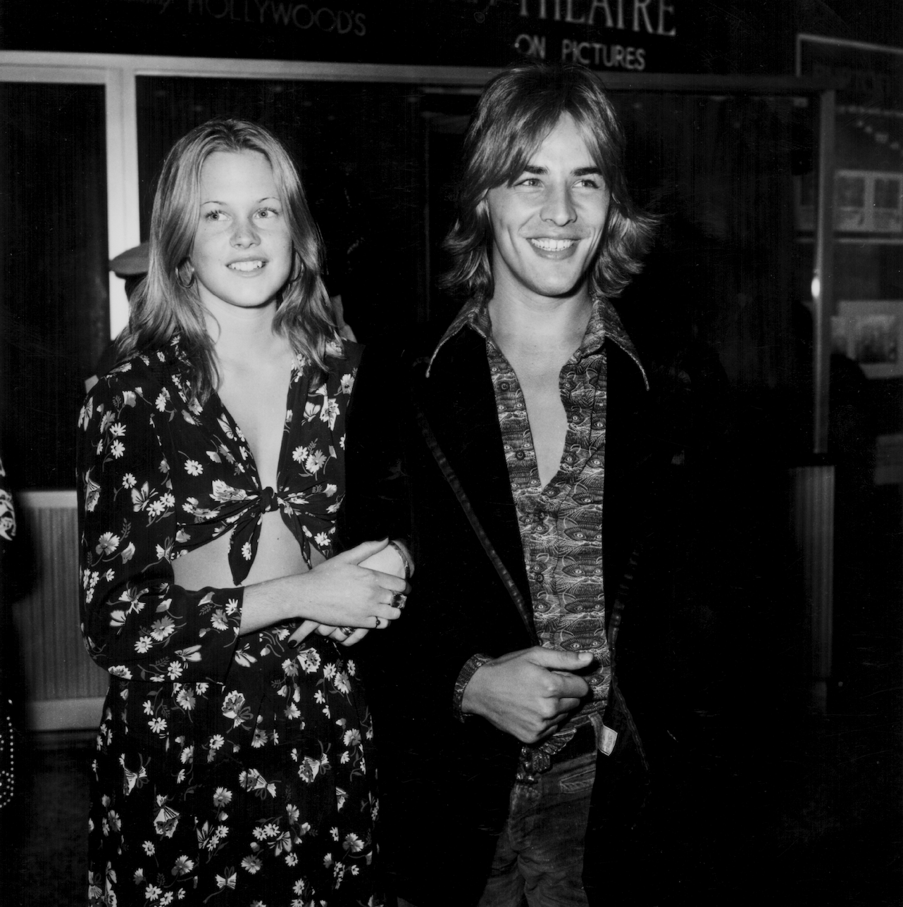 Young Melanie linking arms with Don — both of them smiling.