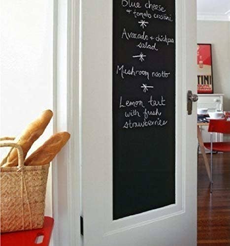 Chalkboard decal in a kitchen with some names of dishes written on it.