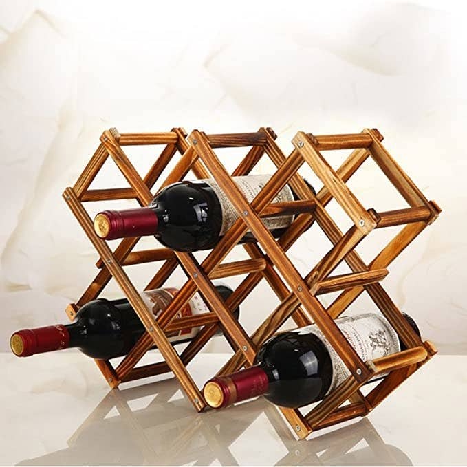 Three bottles of red wine in the wooden wine rack.