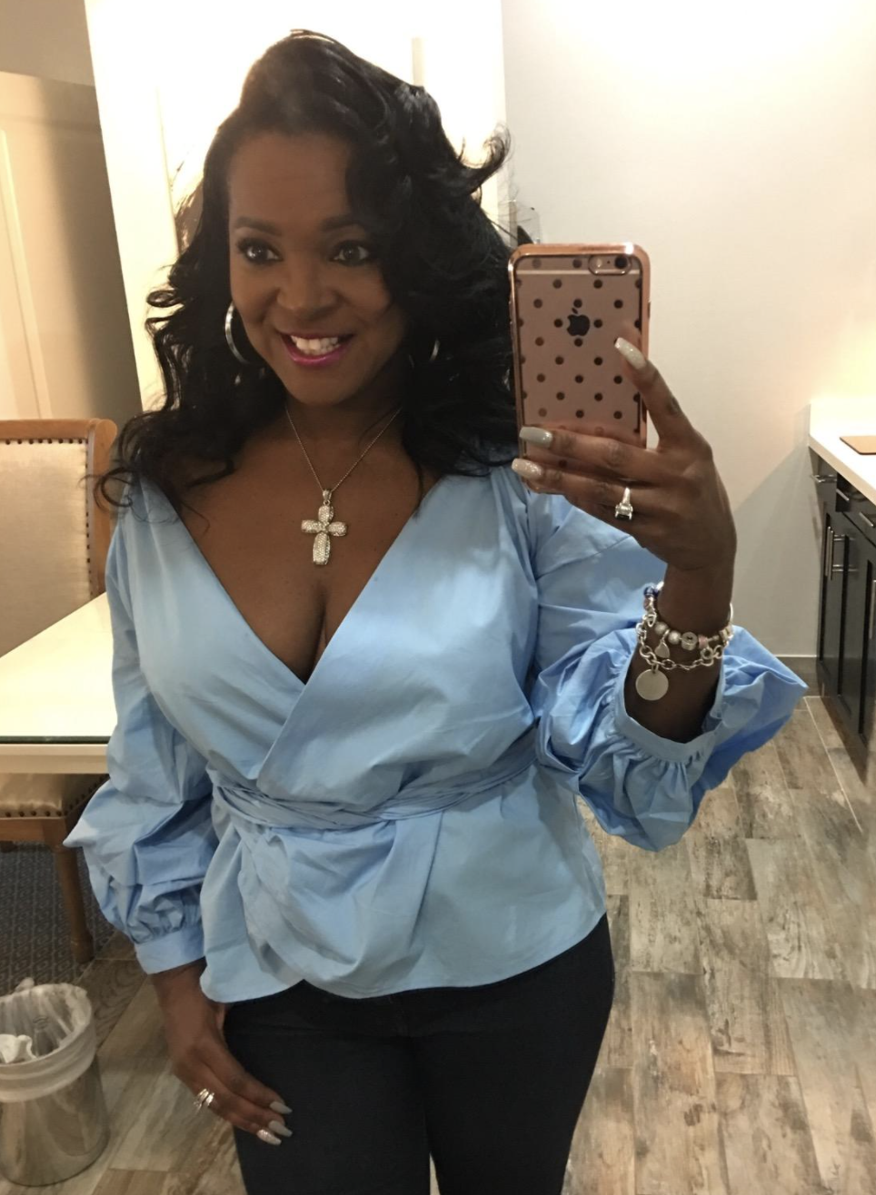 reviewer wearing the blue V-neck wrap top 