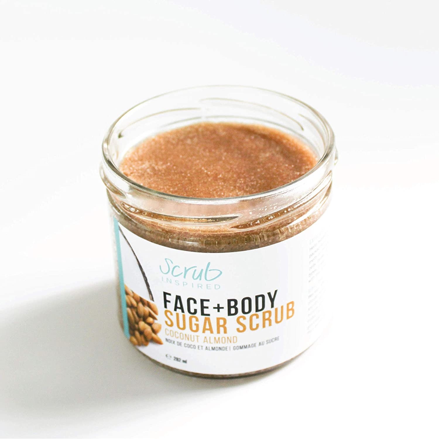 An jar of the exfoliant on a plain countertop to show off the texture of the product