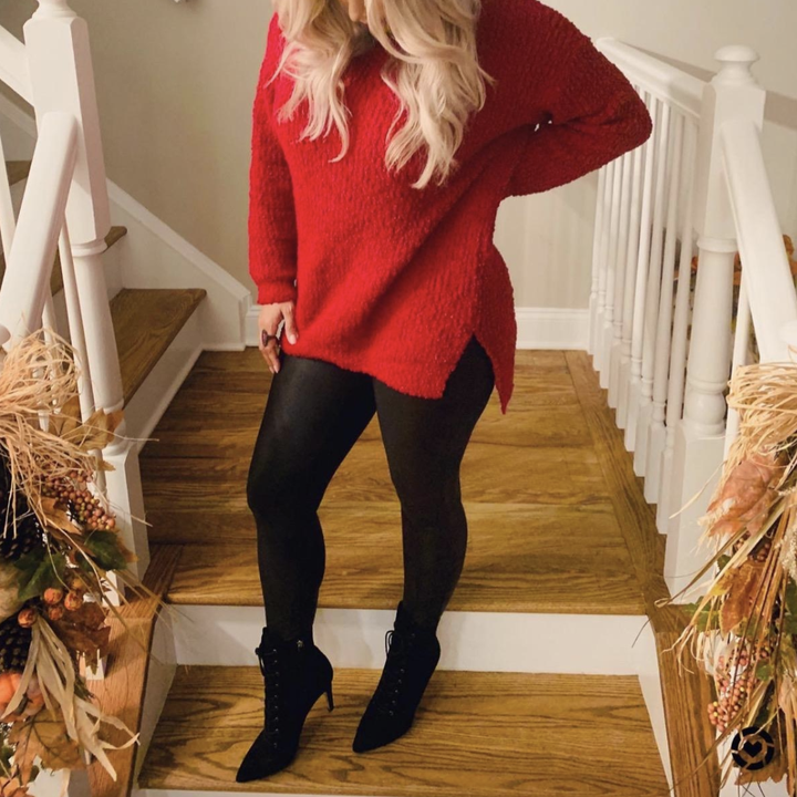 reviewer wearing the red sweater with side slit