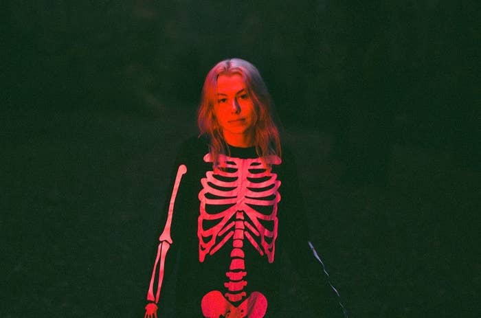 Phoebe standing in the dark in a skeleton costume