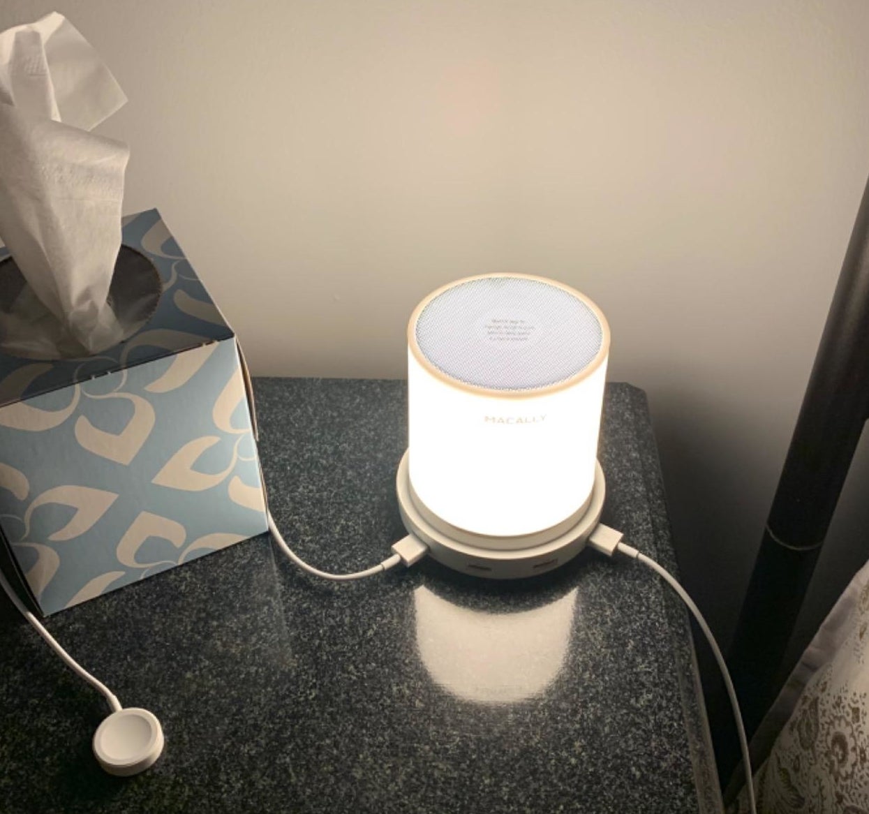 reviewer&#x27;s lamp on a bedside table with a couple chargers plugged into it 