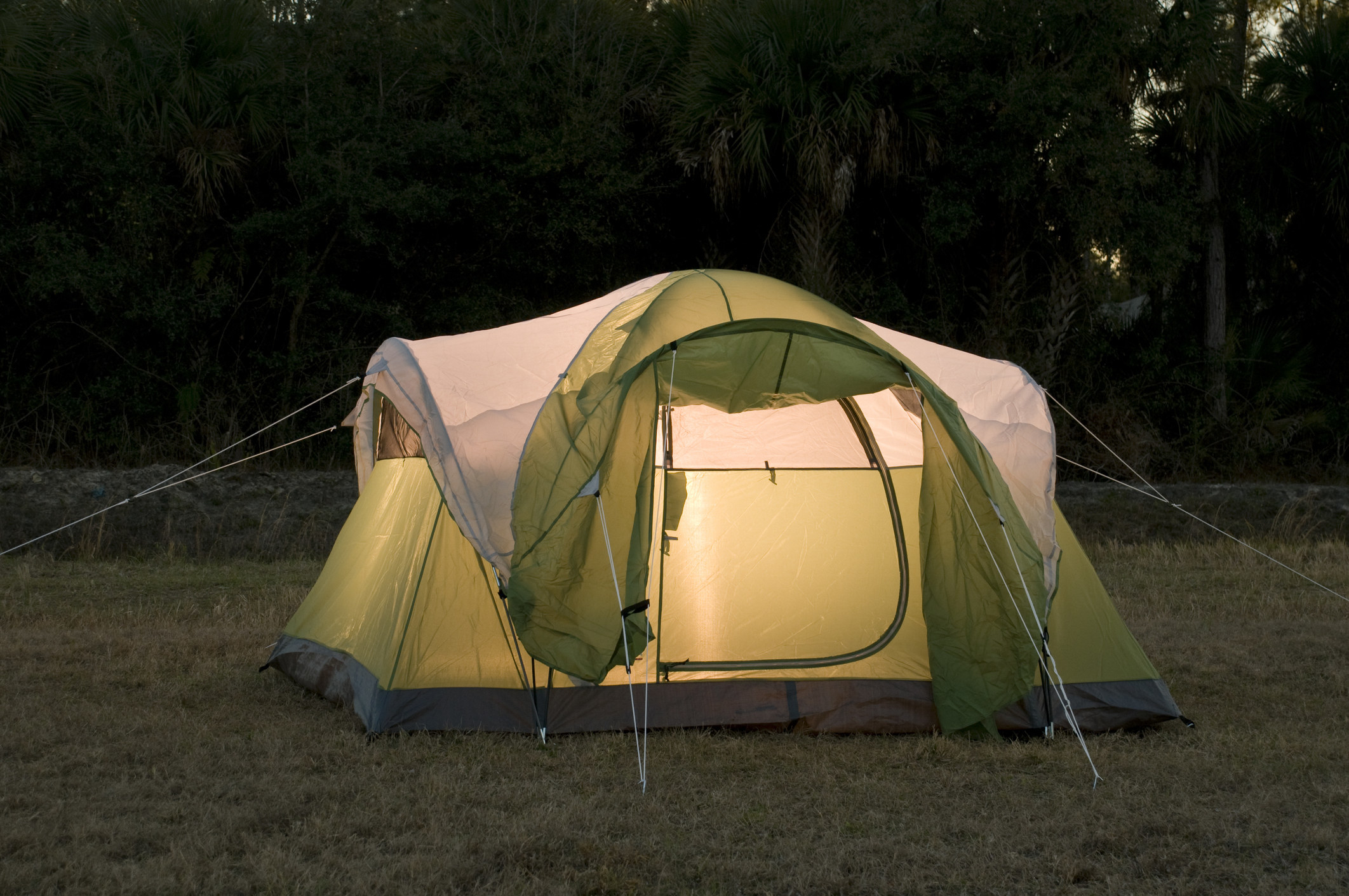 photo of a green tent outdoors during the evening