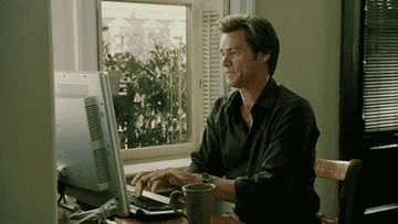Jim Carey in Bruce Almighty typing on his computer.