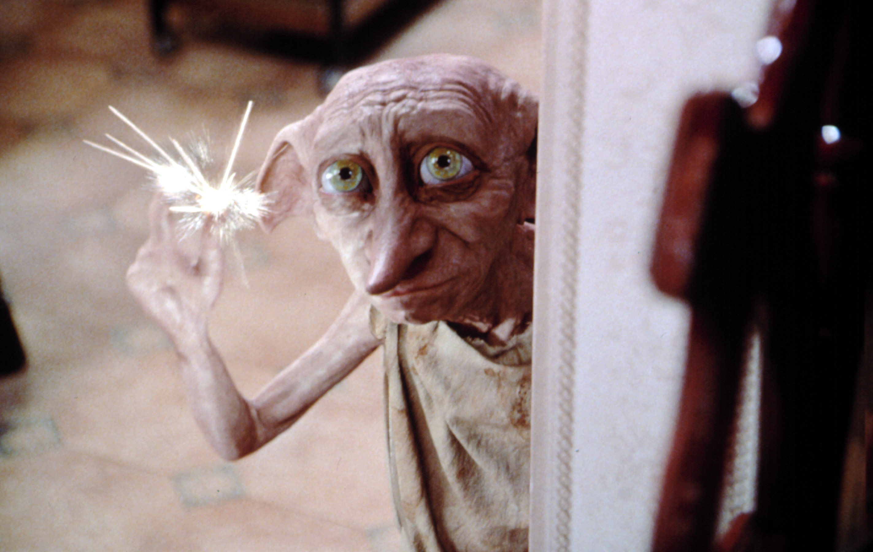 Dobby snapping his fingers and sending sparks into the air