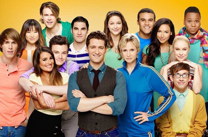 The cast of Glee all lined up and smiling