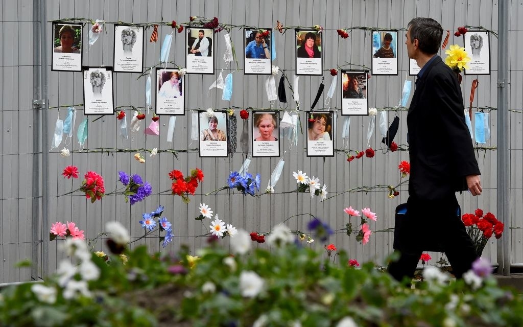 A person walking by a memorial for coronavirus deaths