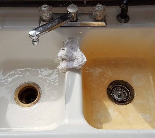 Before-and-after of half of a sink that&#x27;s rusty then clean