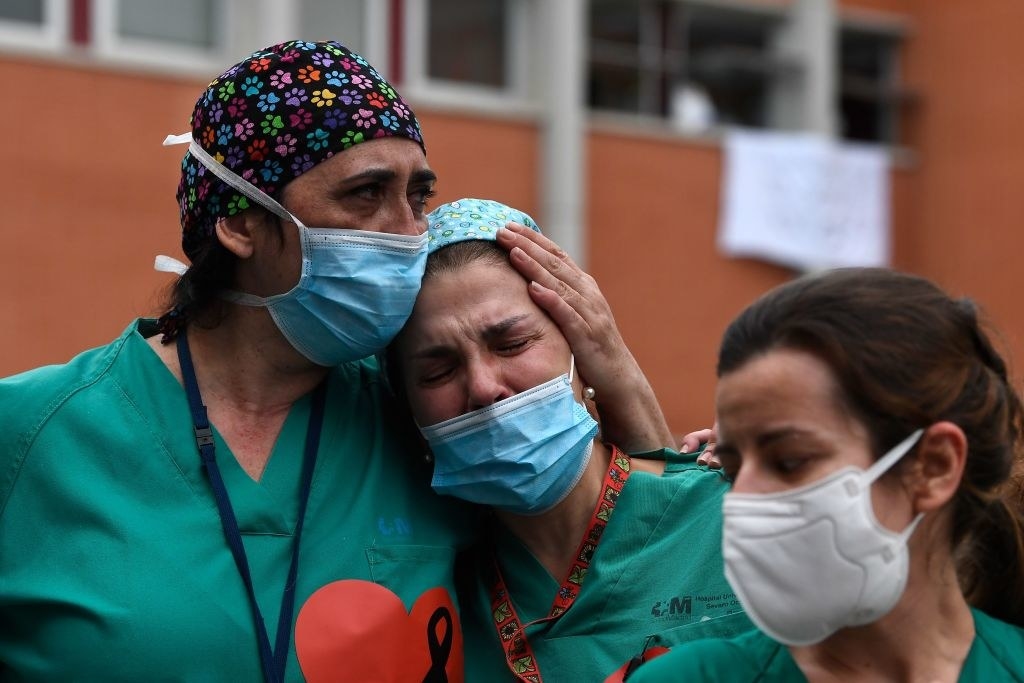 Grieving doctors wearing face masks