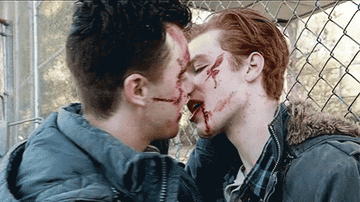 with bloody faces, Mickey and Ian kiss