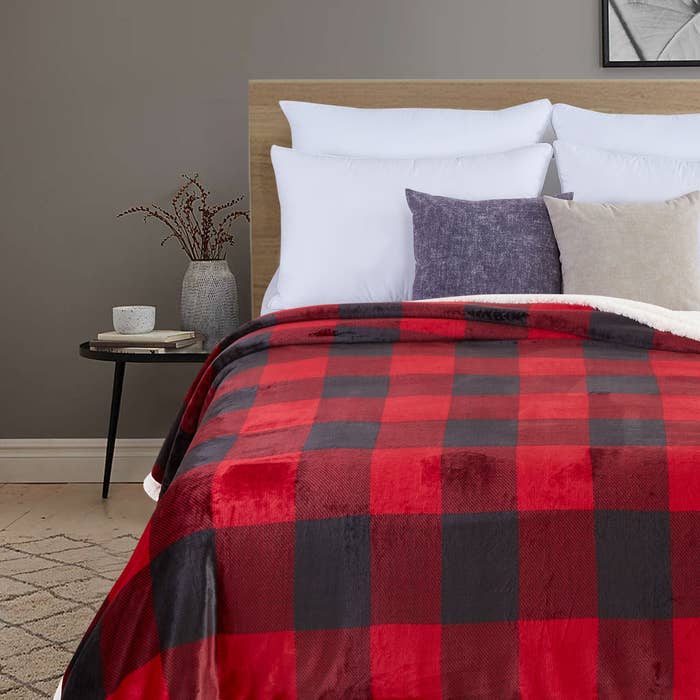 The red plaid blanket on a bed