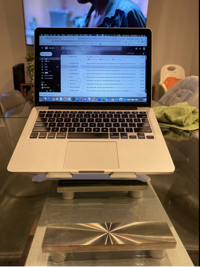 Adjustable laptop stand on a kitchen table