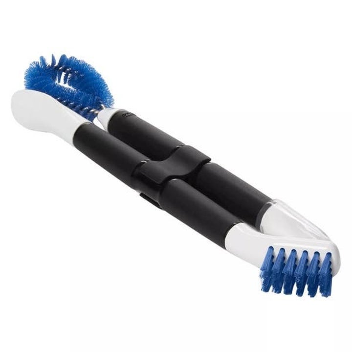 Two double-sided cleaning brushes held together with a snap-on clip