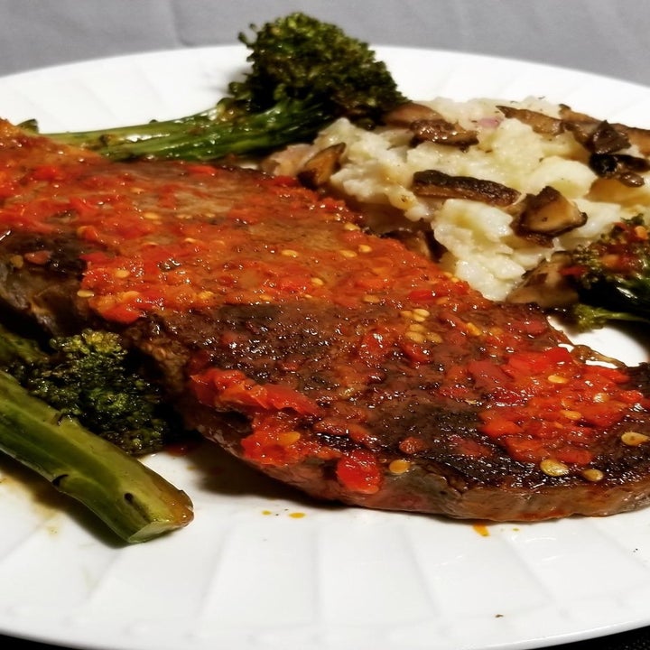 A piece of salmon topped with Calabrian chili pepper paste.