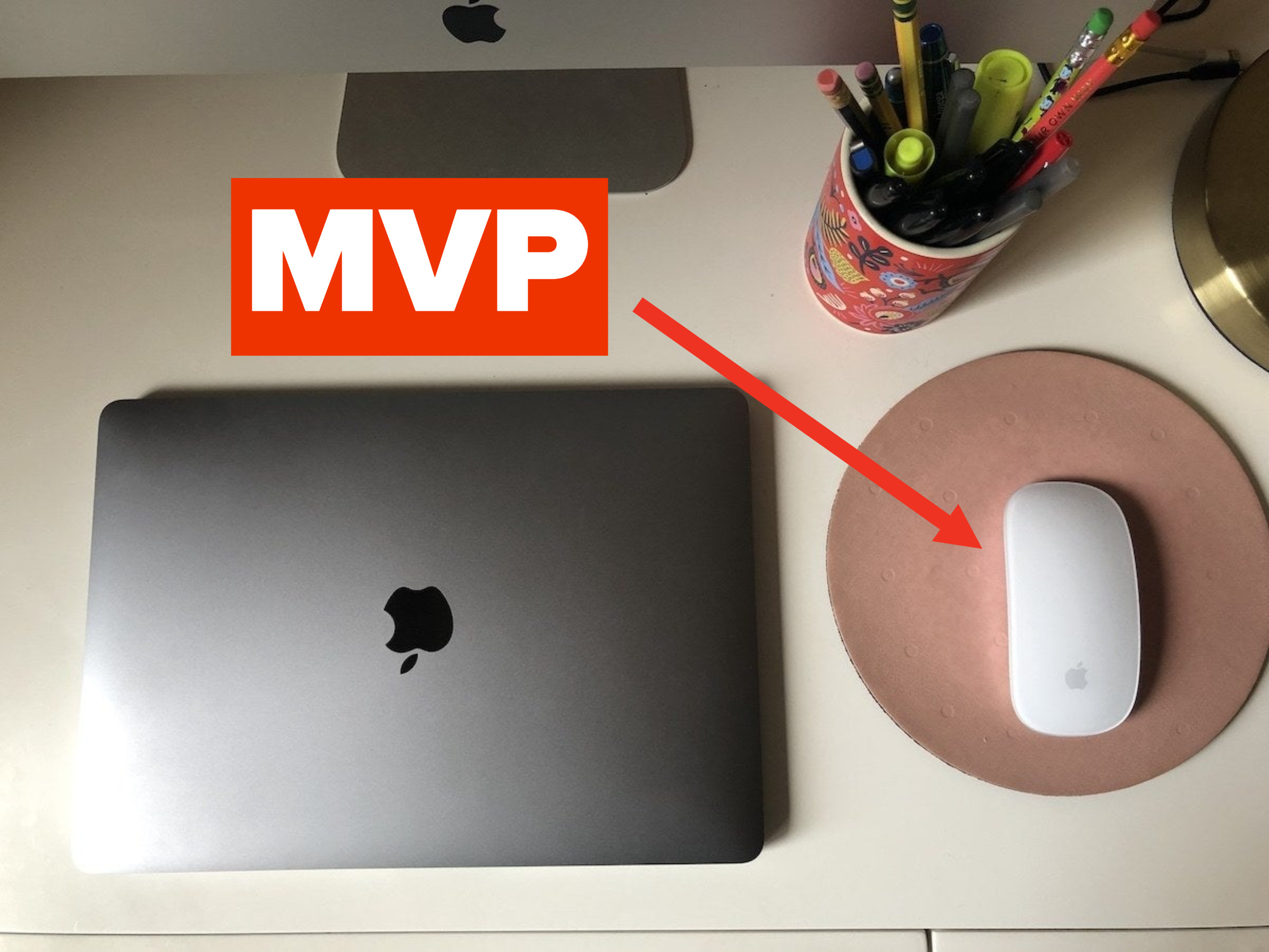 A wireless mouse next to a laptop