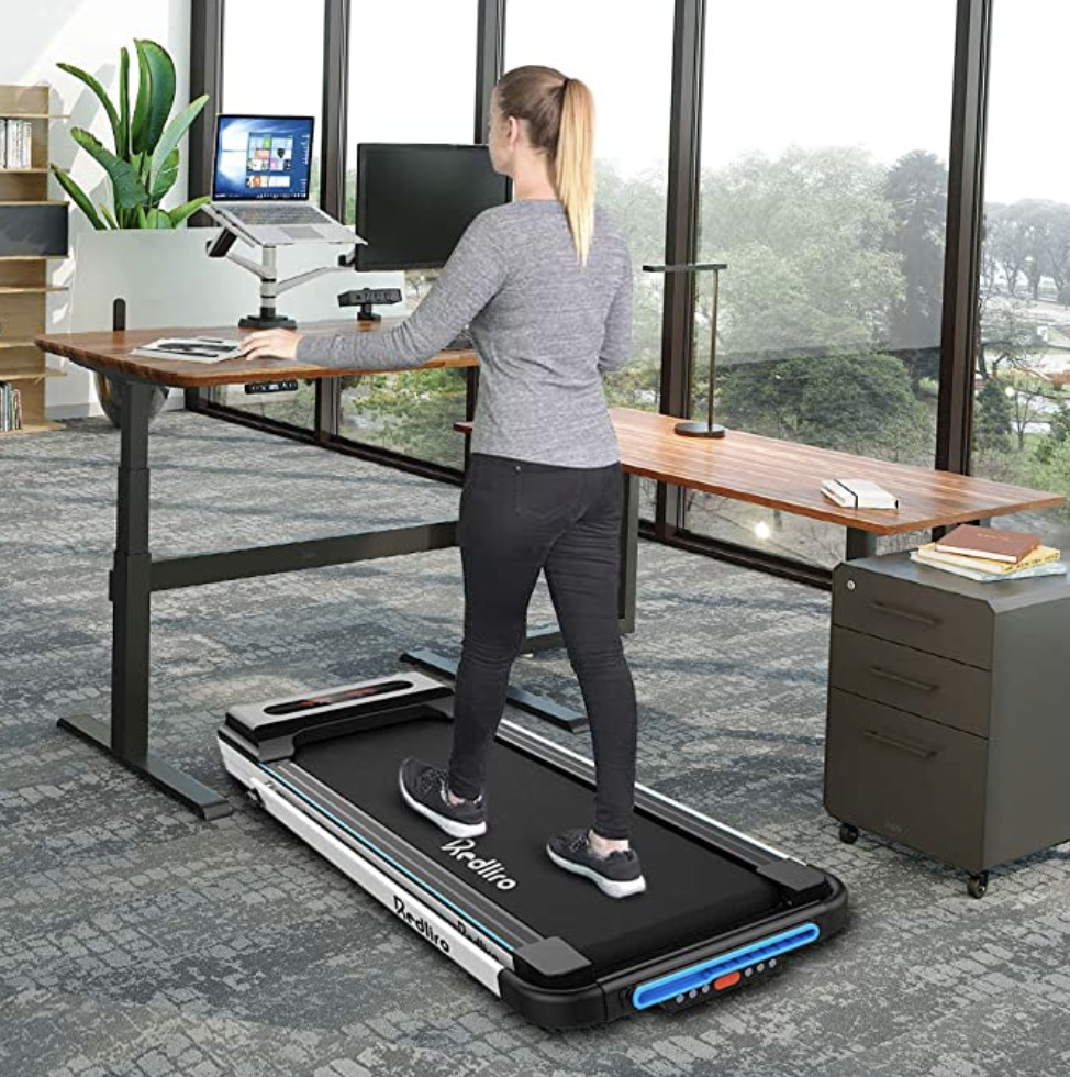 A woman walking on a treadmill desk