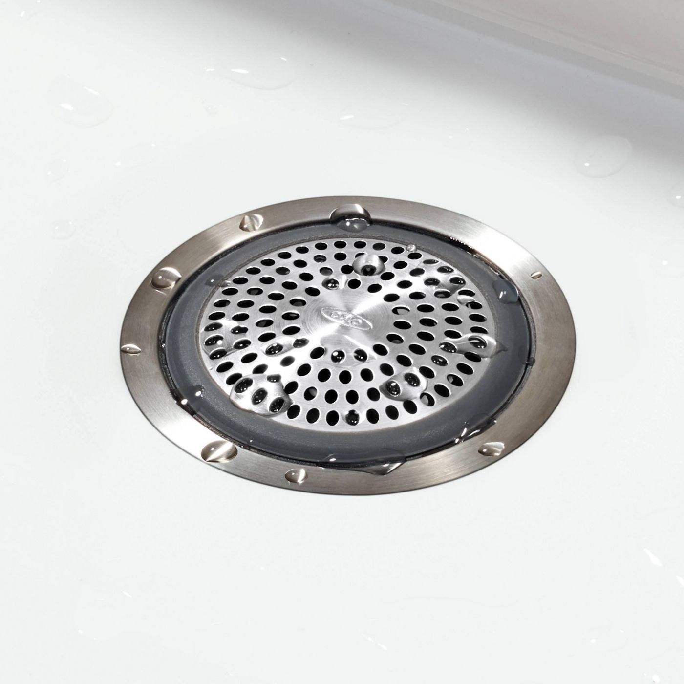 bathtub drain protector in the drain with water droplets around it