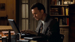 GIF of Tom Hanks typing furiously on his laptop, with an obviously frustrated expression