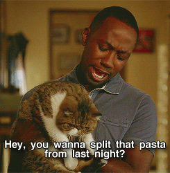 GIF of Winston from &quot;New Girl,&quot; cuddling his cat and asking him if he wants to split the &quot;pasta from last night&quot;