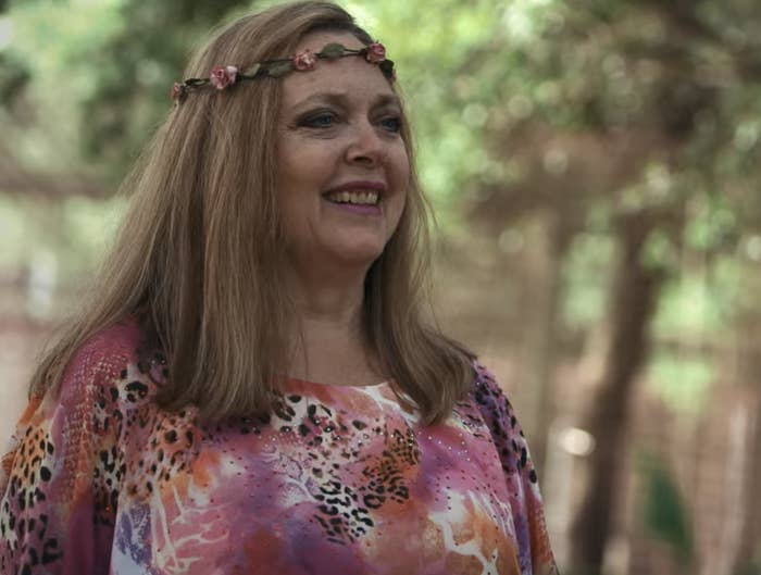 Carole in a flower crown and animal-print shirt