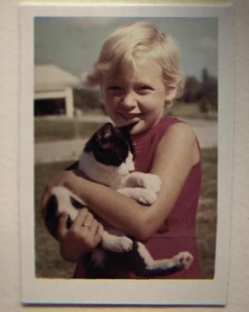 Carole as a child, holding a cat