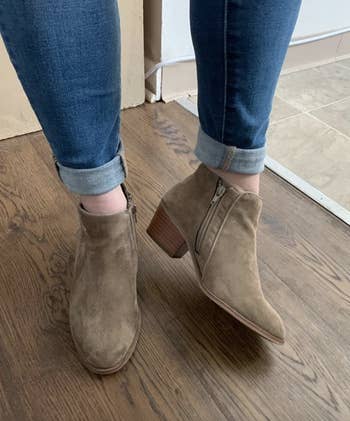 reviewer wearing the taupe booties 