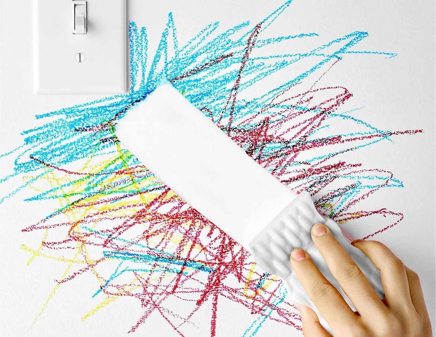 A Magic Eraser removing crayon from a wall