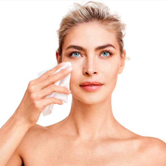 A person uses the exfoliating cloth to wipe their face