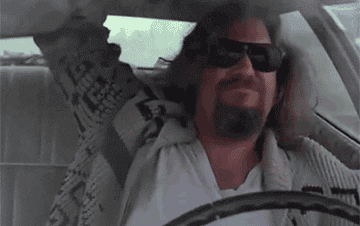 A man pumping his arm up in excitement while driving