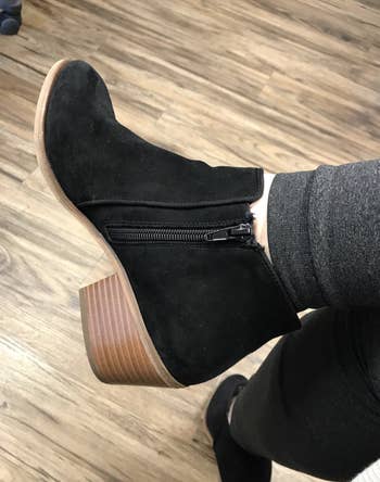 reviewer wearing the black booties 