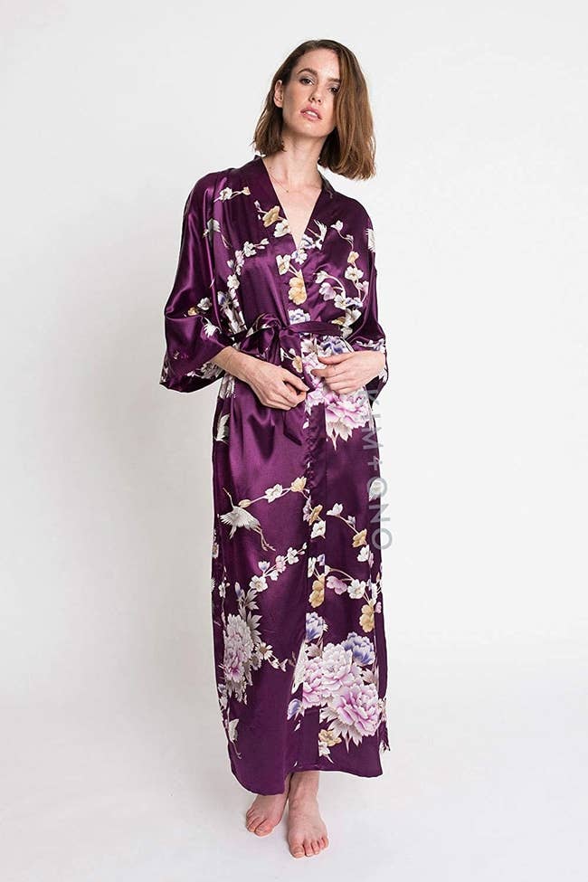 A model wears the KIM+ONO satin kimono robe in the plum Chrysanthemum & Crane design
