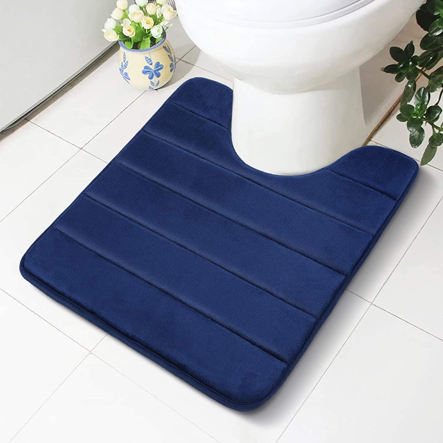 The toilet mat surrounding the base of a toilet
