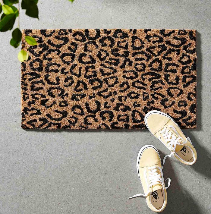 A pair of Vans sneakers on the leopard print mat