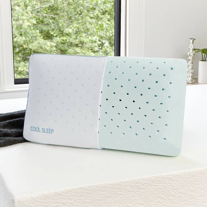 The pillow, half in the case and half out of the case, with its perforated foam visible