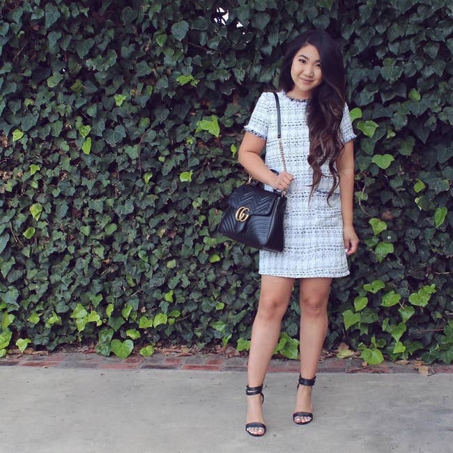 A reviewer wearing the gray and white tweed short sleeve mini dress