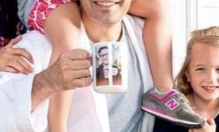 A closeup of Jimmy Fallon holding a mug of Justin Timberlake's face.