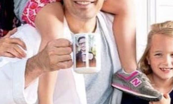 A closeup of Jimmy Fallon holding a mug of Justin Timberlake&#x27;s face. 