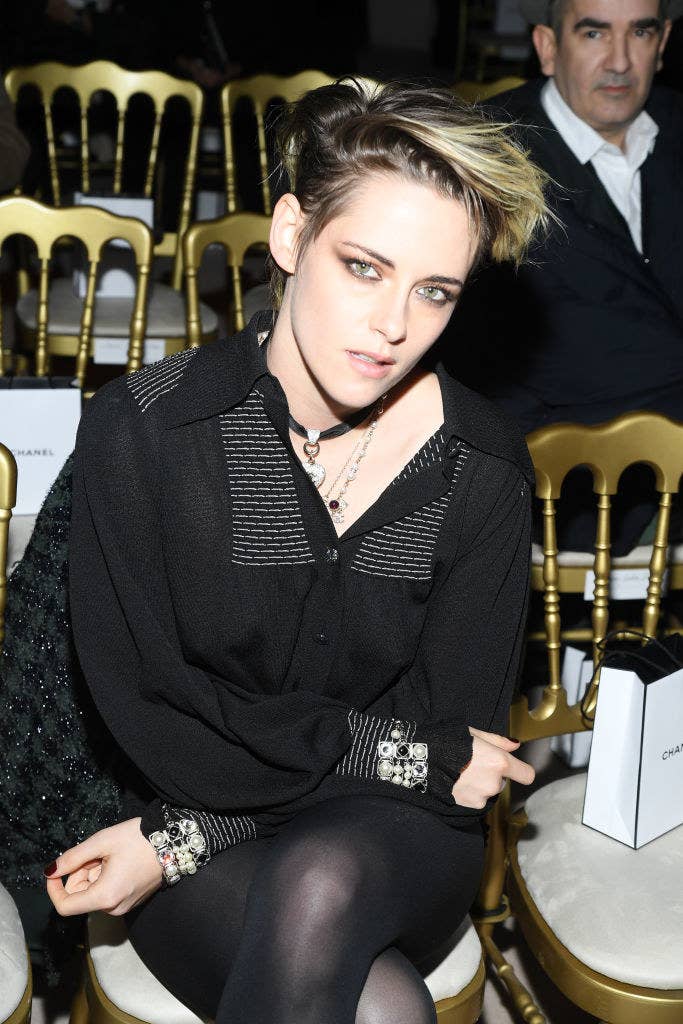 Kristen with dramatic makeup and a button-up dress over tights