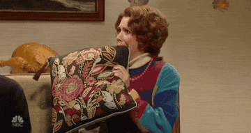 Kristen Wiig scared and chewing on a pillow in an &quot;SNL&quot; sketch