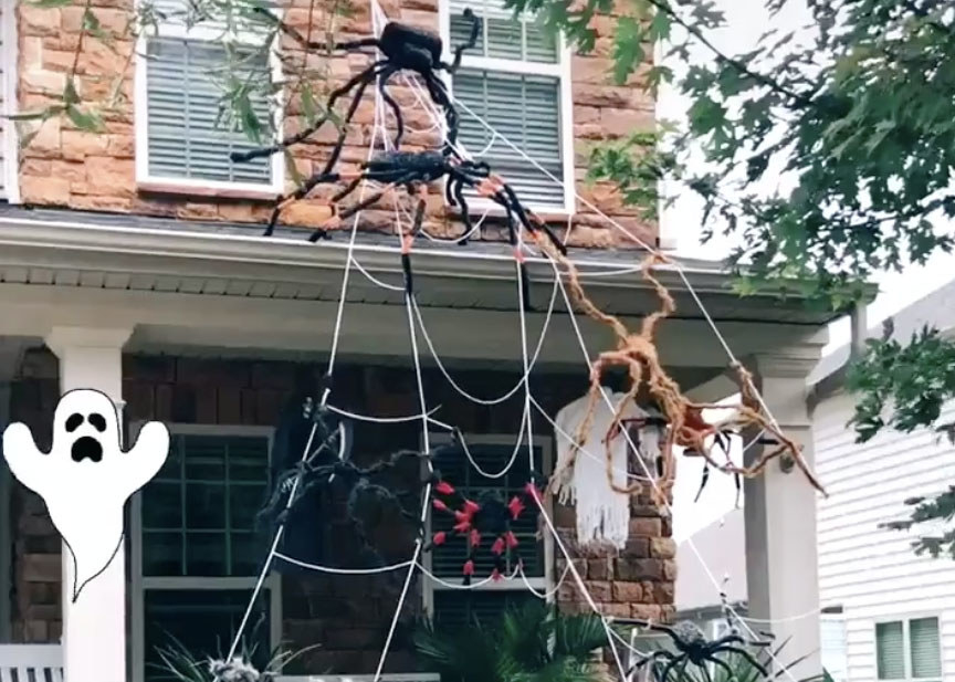 A home with a large spiderweb spanning two stories