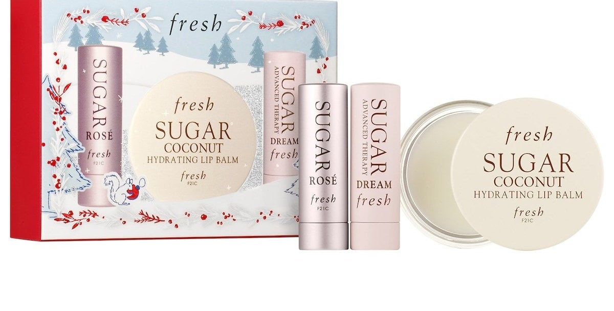 Sugar Lip Balm Rose and Dream Tins and the Sugar Hydrating Balm pan with holiday-themed packaging. These products are formulated without sulfates (SLS and SLES), parabens, phthalates, and more