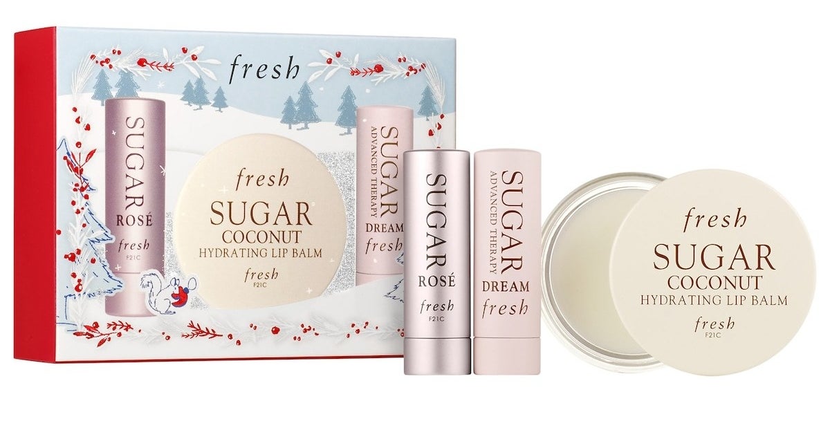 Sugar Lip Balm Rose and Dream Tins and the Sugar Hydrating Balm pan with holiday-themed packaging. These products are formulated without sulfates (SLS and SLES), parabens, phthalates, and more