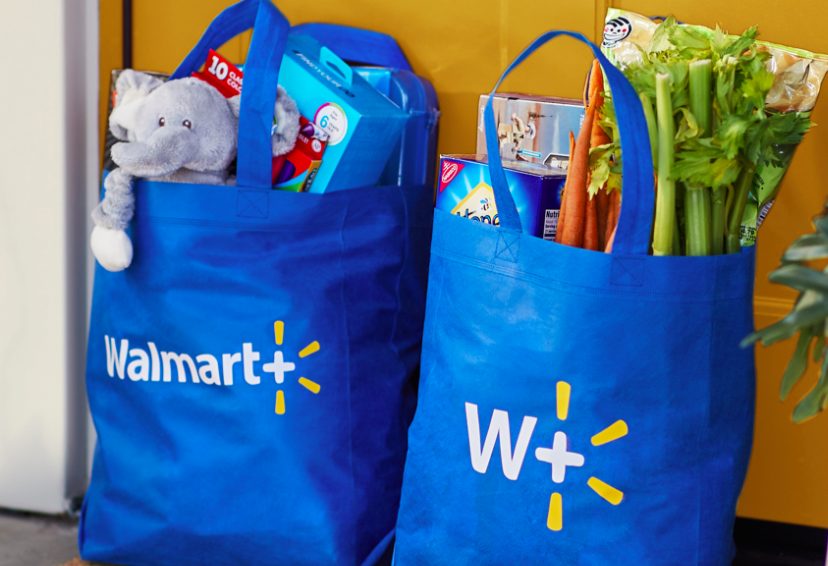 Walmart+ bags filled with groceries placed on a doorstep 