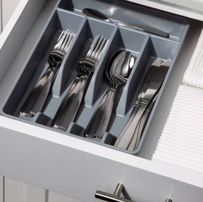 The drawer organizer in gray holding silverware