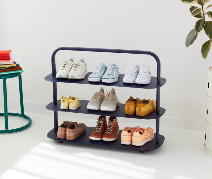 The navy shoe rack which has a handle on top
