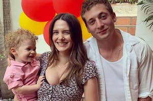 Jeremy Allen White and Addison Timlin taking a photo with their daughter